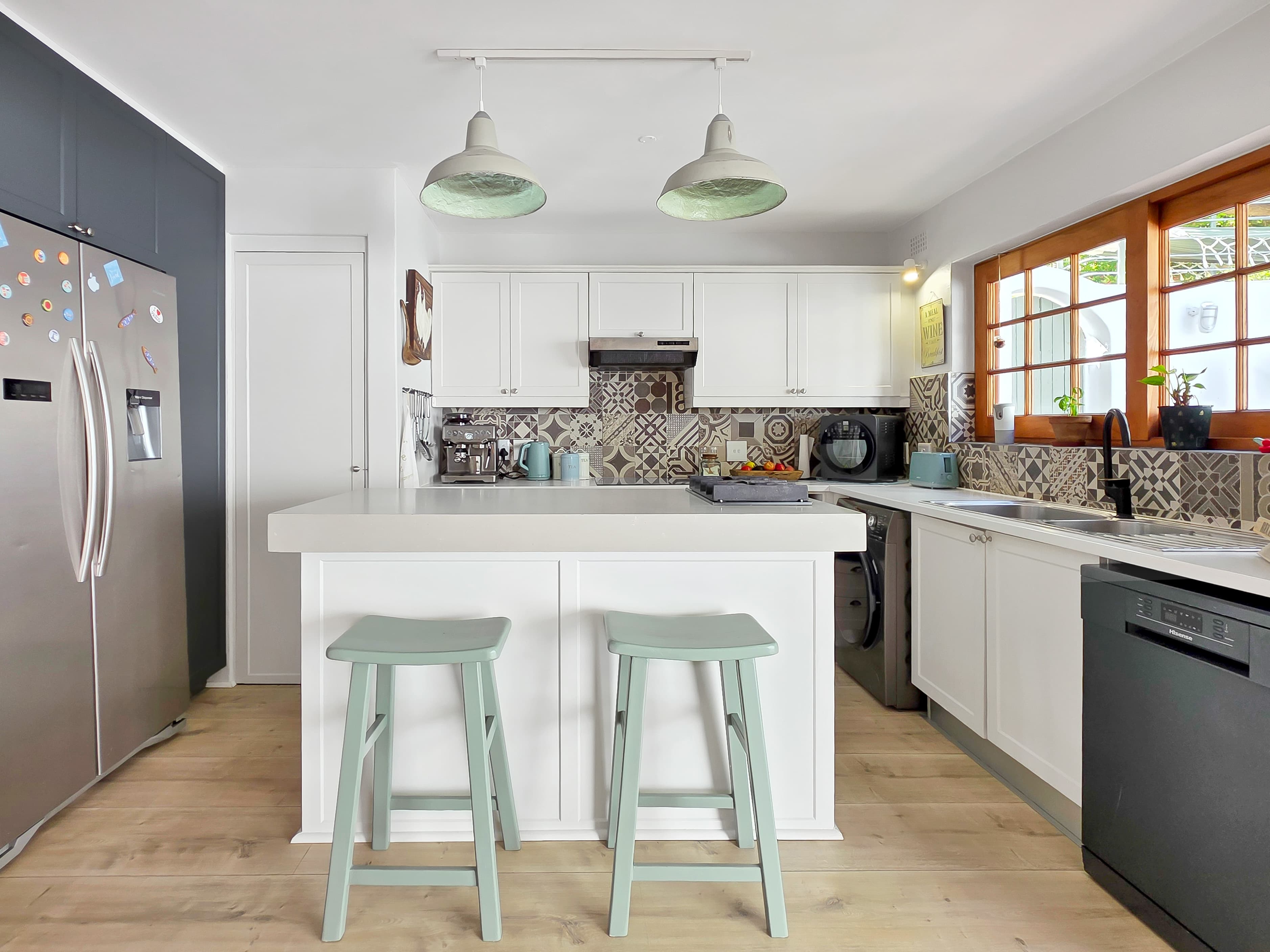 The kitchen with stools for casual eating.