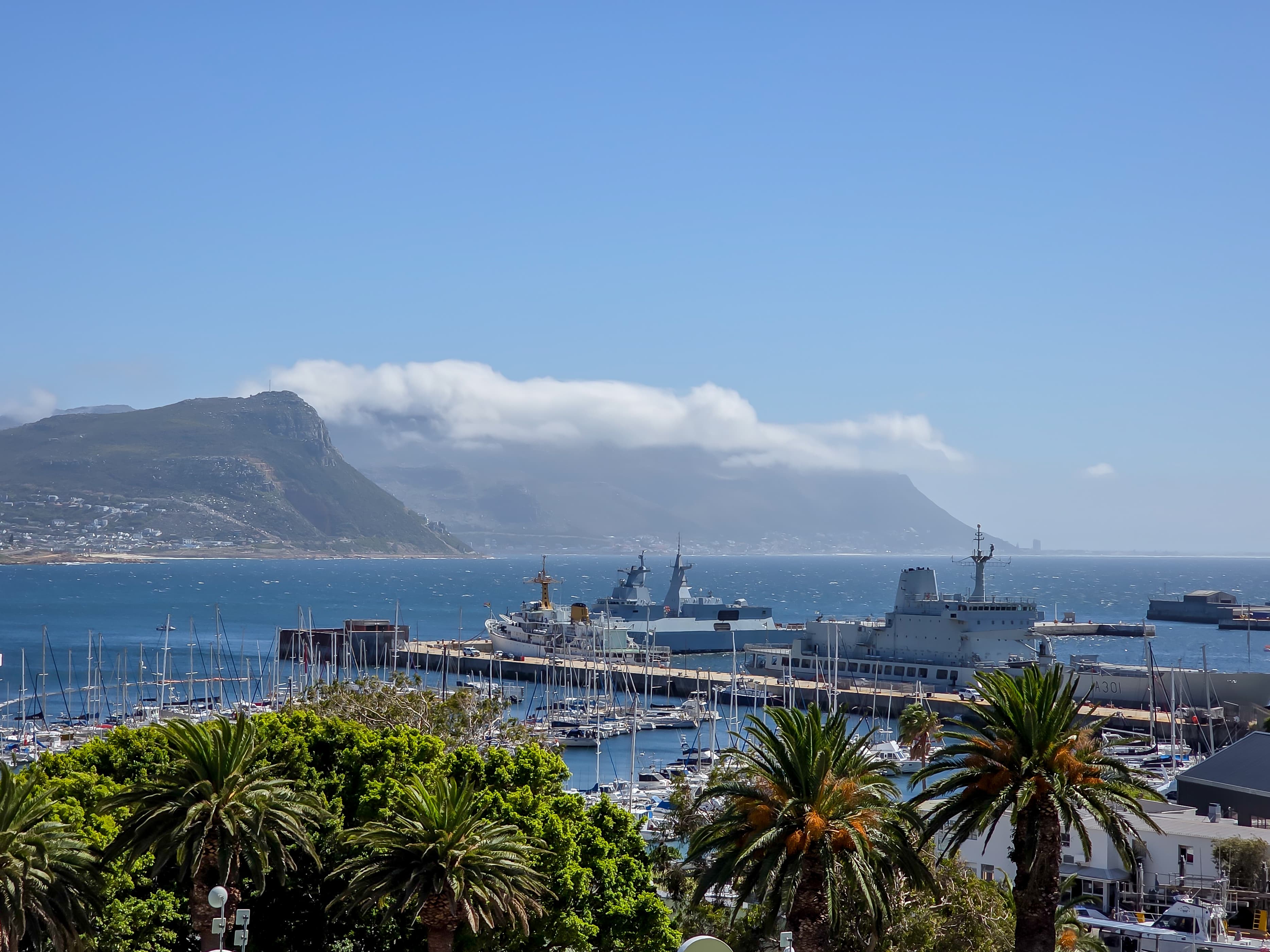 The view of the village, yacht basin and False Bay, with Kalk Bay and Muizenberg in the distance.